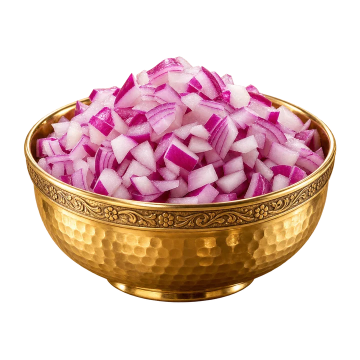 Fresh diced red onion in a gold bowl